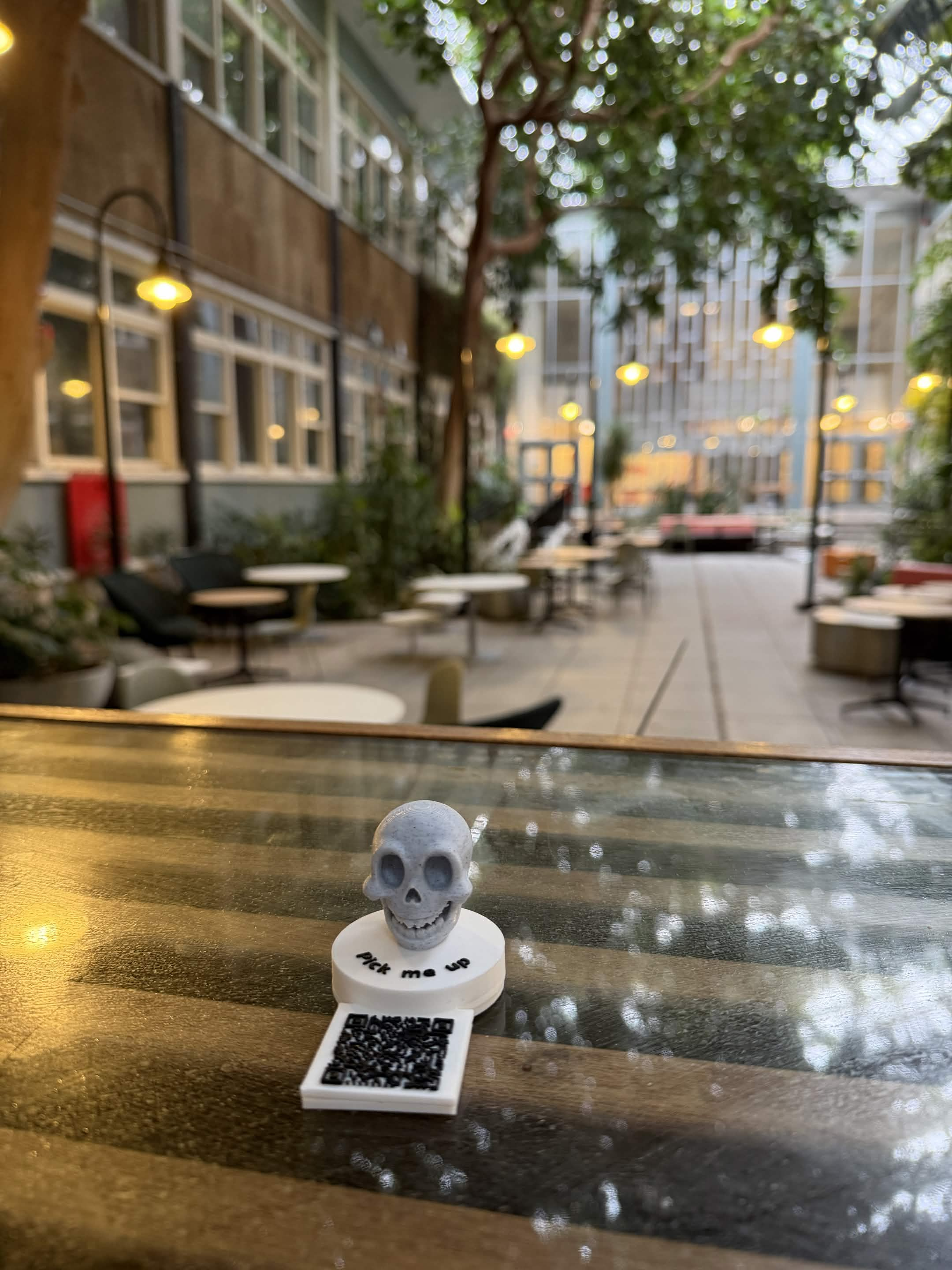 One of the five physical markers, a small skull with a QR code, waiting to be found
